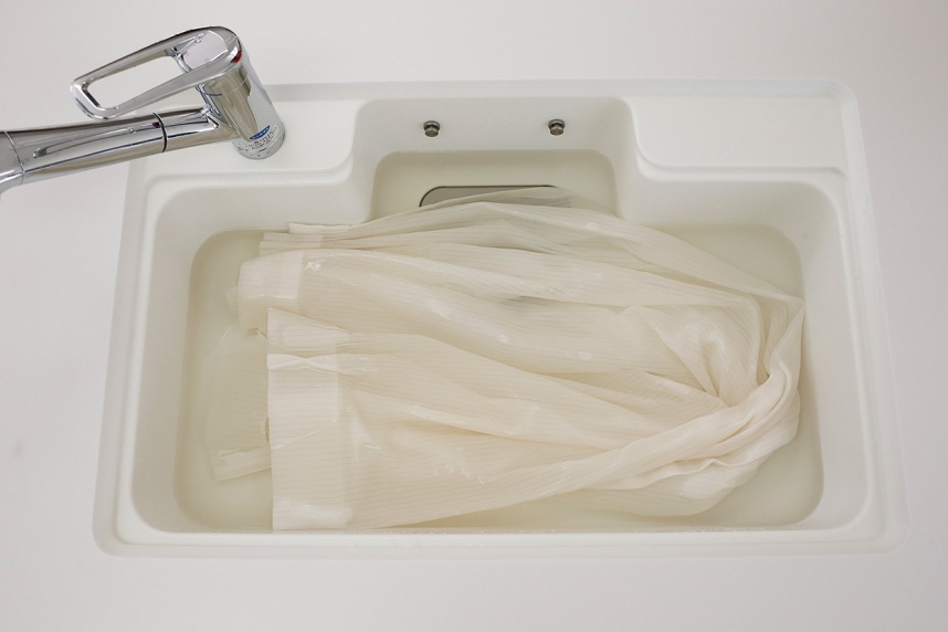 酸素の洗剤サンソリキの溶液に黄ばんだカーテンをつけ置き